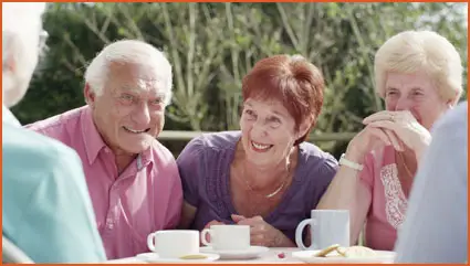 Group of neighbors at dining table during social hour